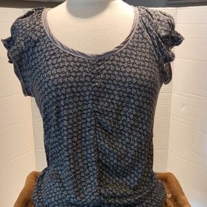 Juicy Couture Knit Top W/ Ruffled Short Sleeves. Grey Background w/ Black Design
